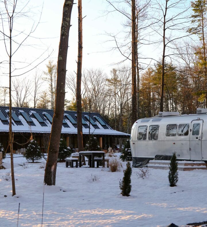AutoCamp Catskills in winter after fresh snow. Outdoor view of Airstream and clubhouse