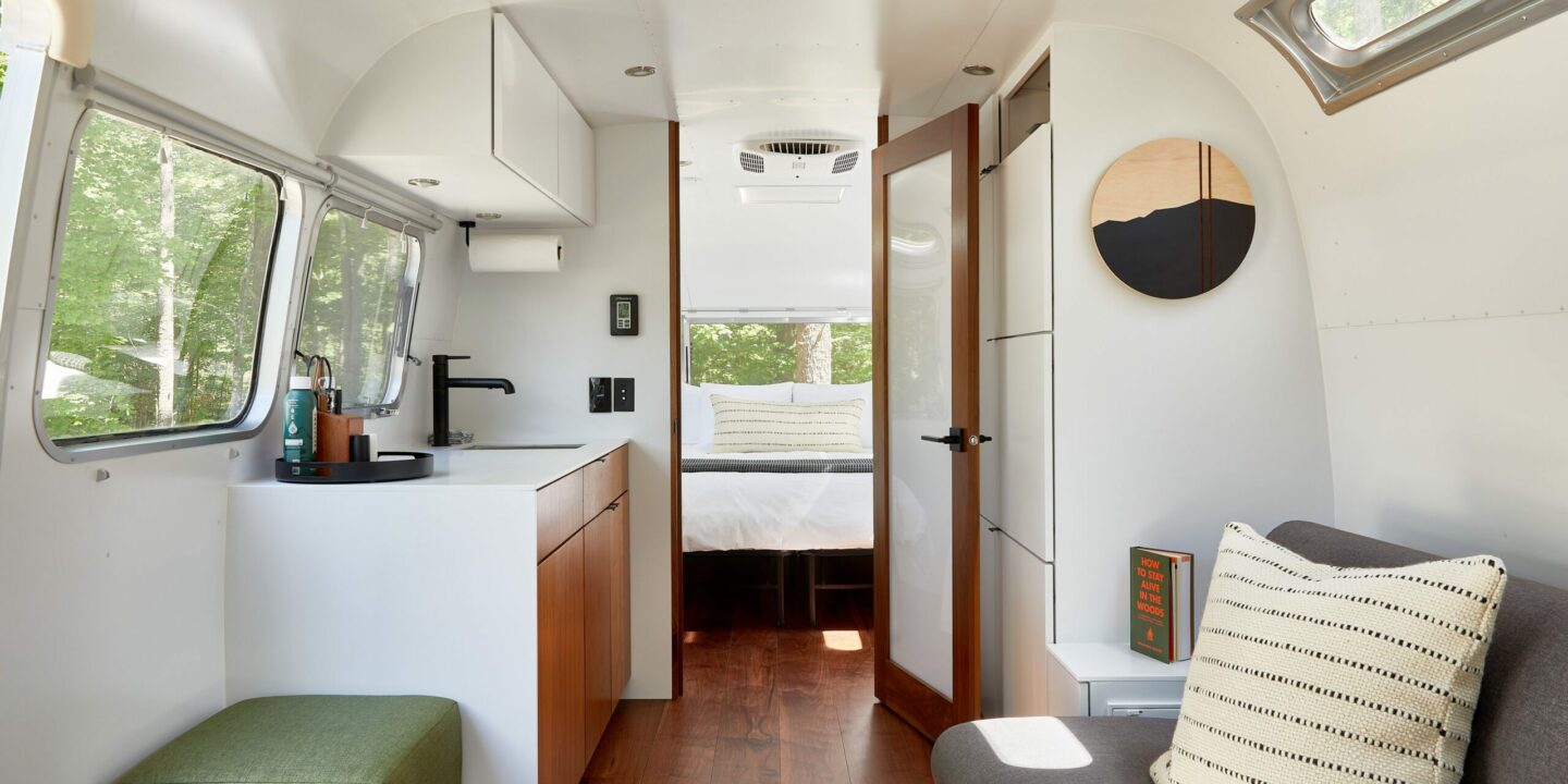 Airstream Interior with bedroom, couch, small kitchen area and bathroom