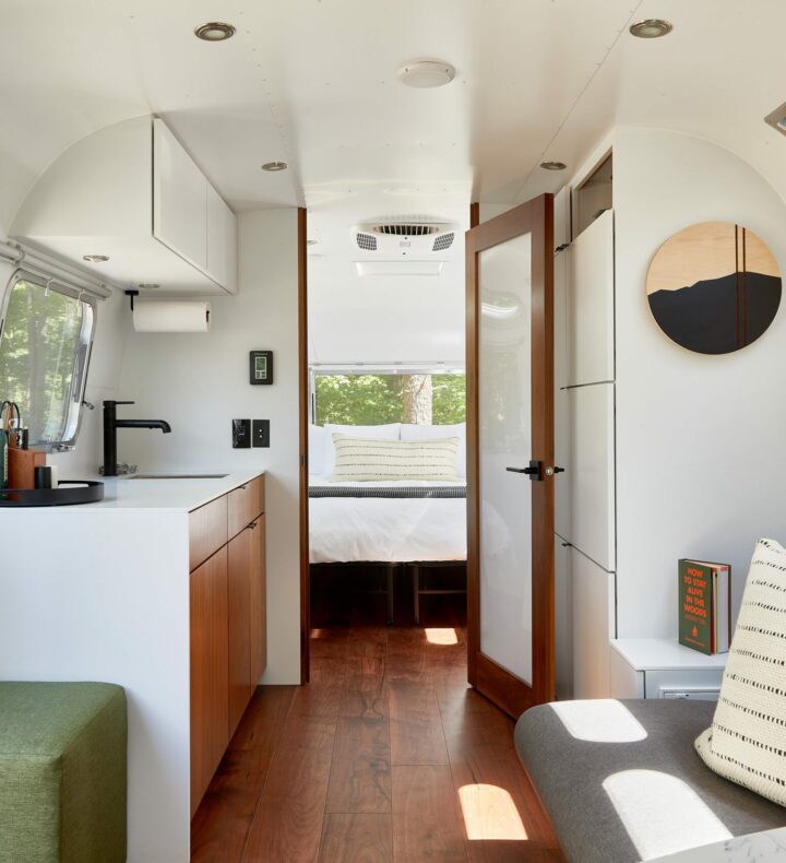 Airstream Interior with bedroom, couch, small kitchen area and bathroom