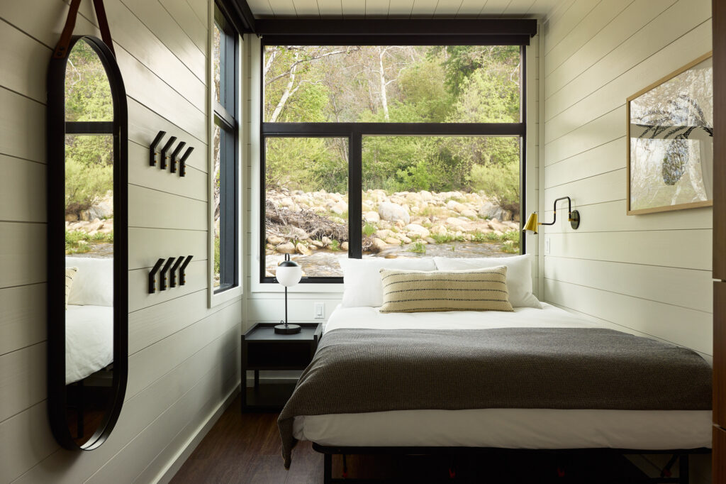 AutoCamp Sequoia Vista cabin suite bedroom view with river outside window