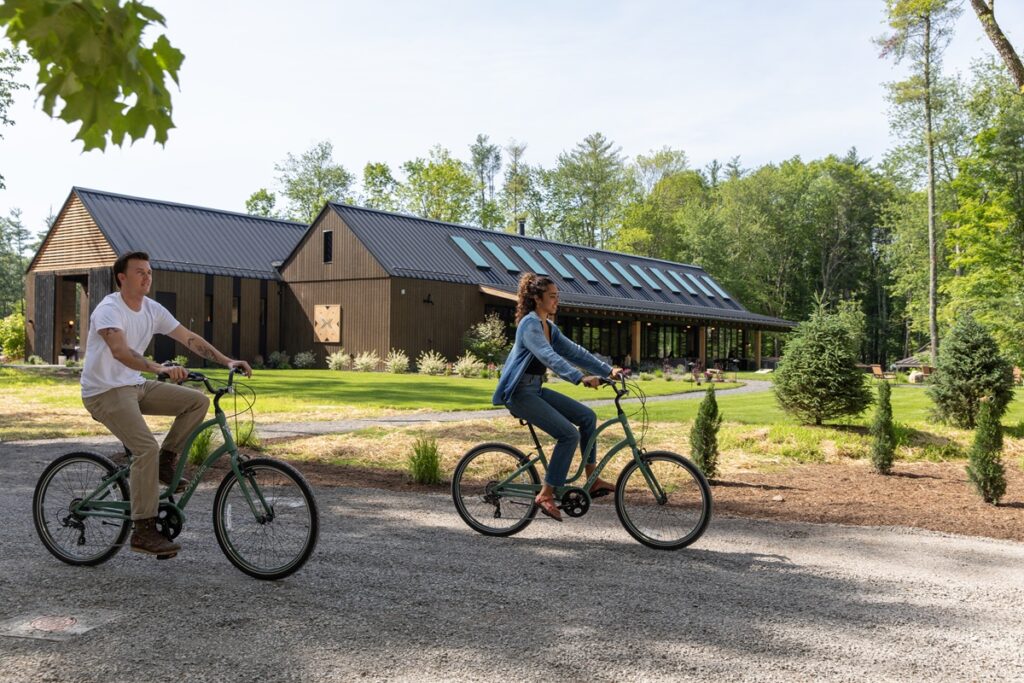Man and woman biking through campground