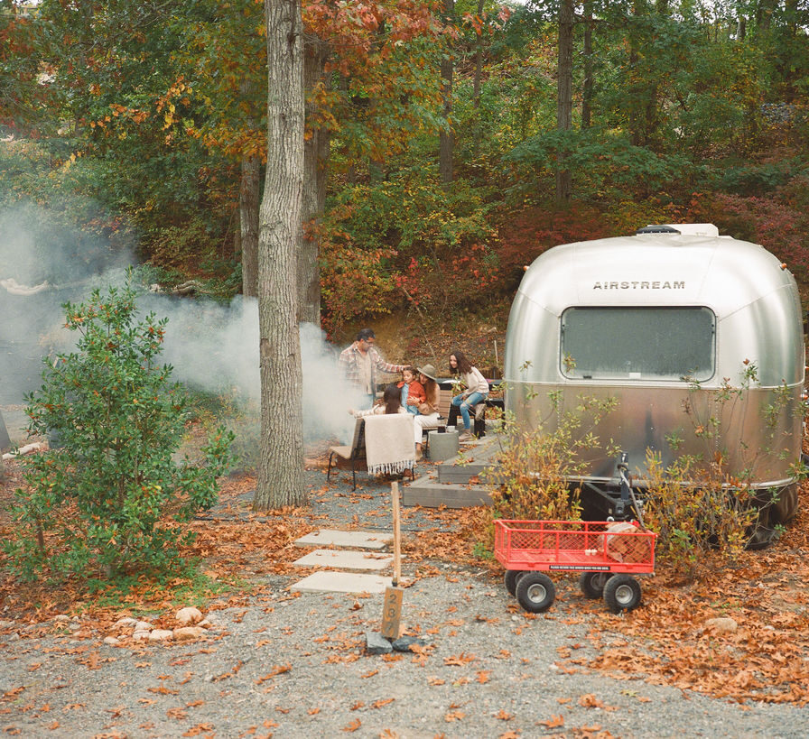 AutoCamp Cape Cod Airstream Suite in the Fall with colorful leaves and cozy fire going
