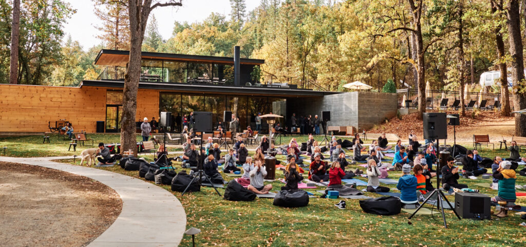 ACY - Group doing outdoor yoga in front of Clubhouse