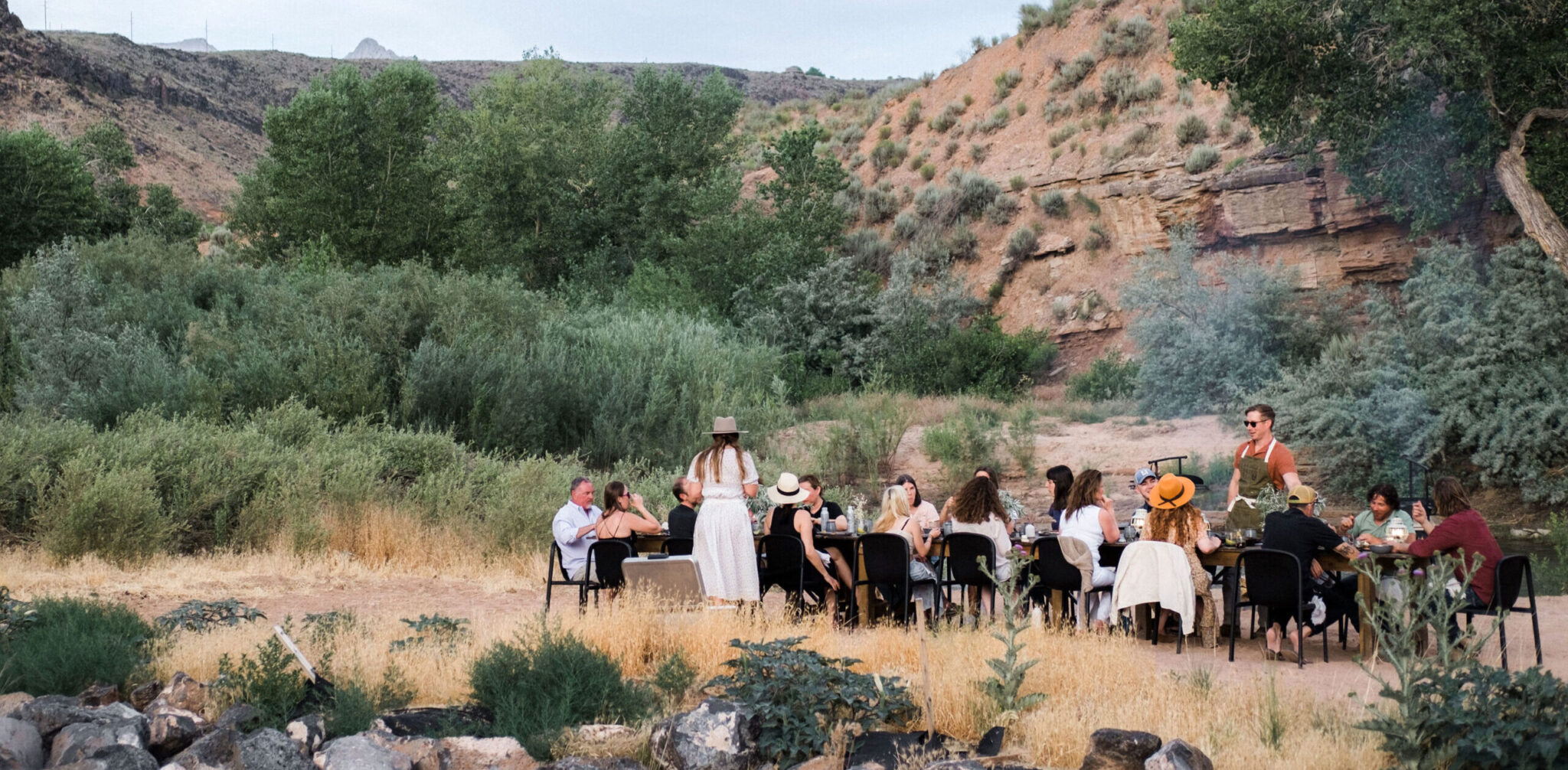 People gathered outdoor to eat in nature