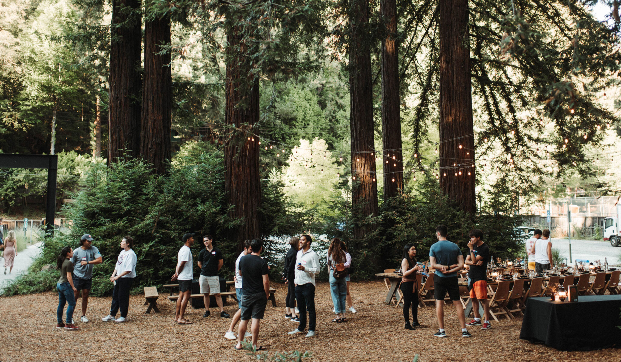 ACRR - Group standing around in nature with dining area in background