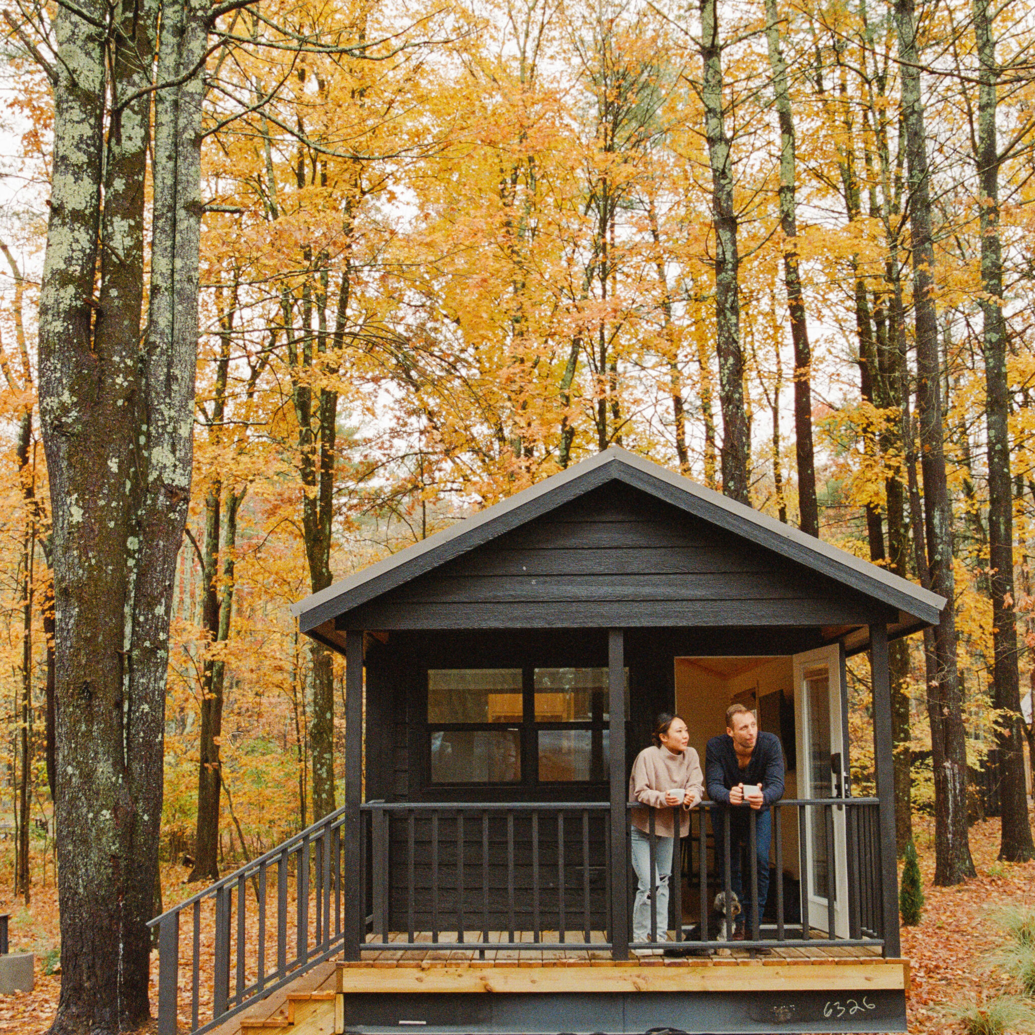 Couple standing outside of a cabin