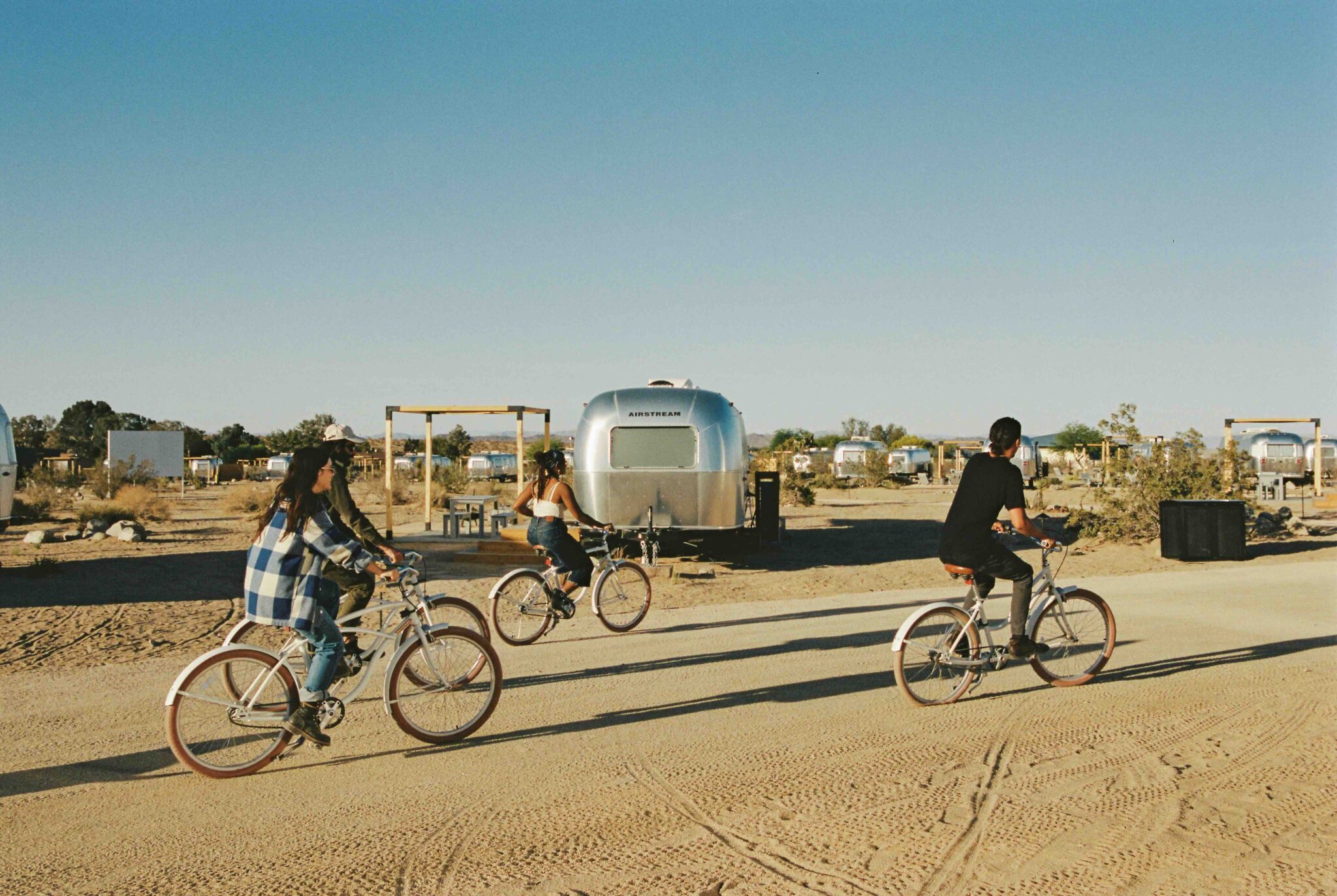 ACJT - People biking near airstreams