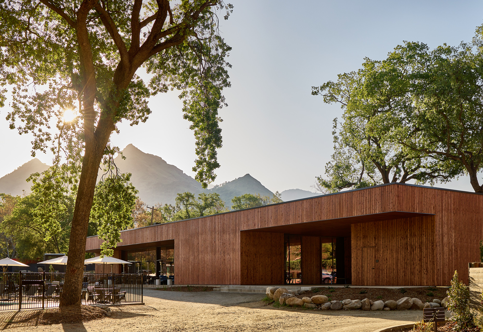 AutoCamp Sequoia Clubhouse at sunrise with mountain backdrop