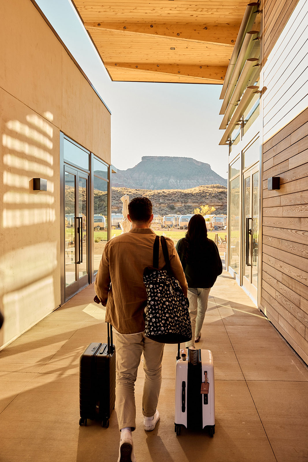 Couple bringing suitcases into Zion