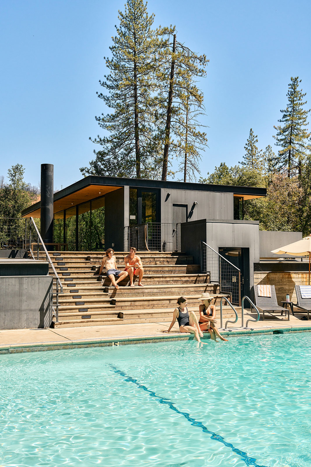 Two couples at the pool at AutoCamp Yosemite