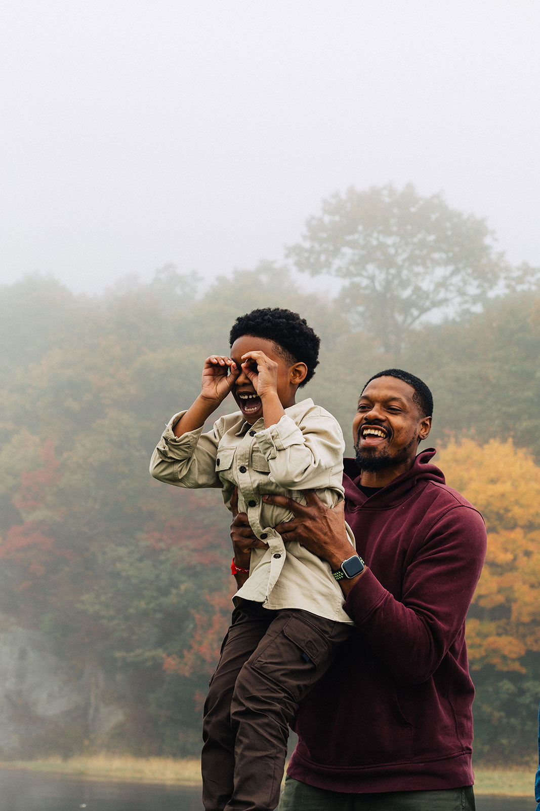 Dad holding son up laughing