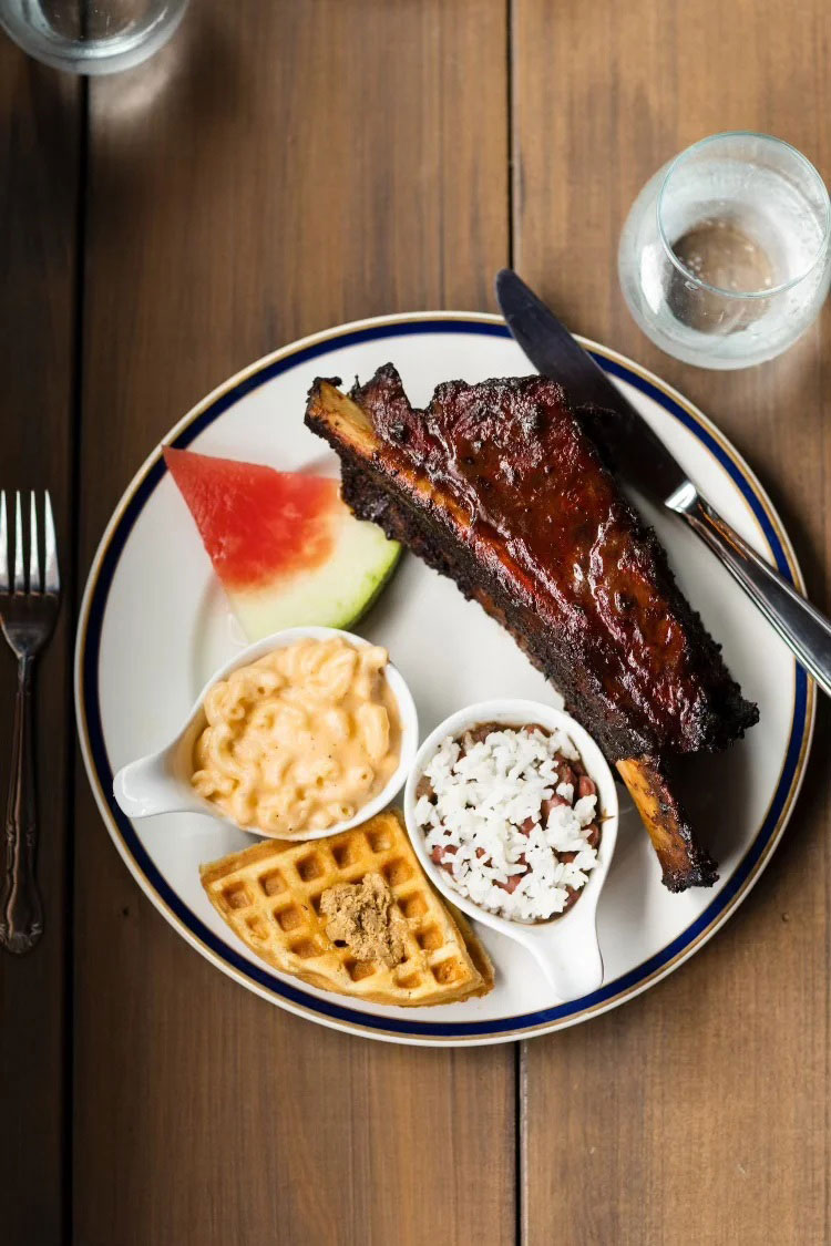 Meal of waffles and ribs