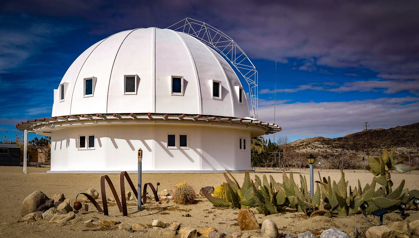observatory in the Joshua Tree desert with cacti in front