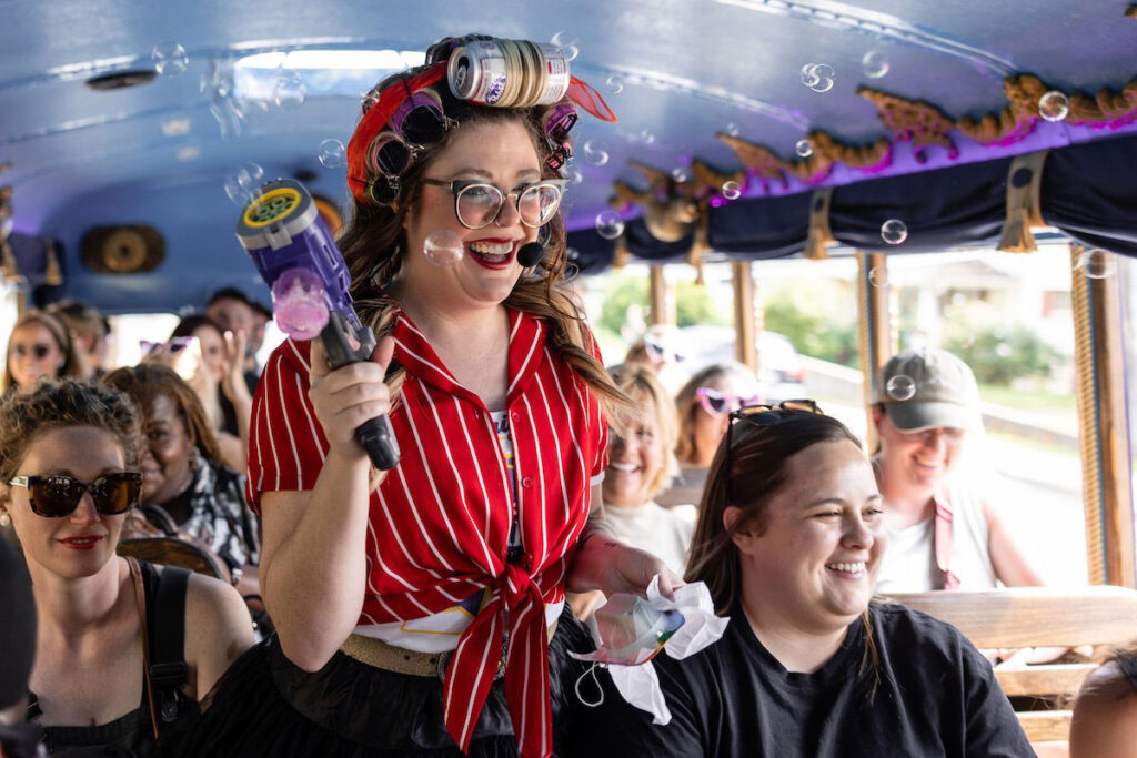Woman on a party bus with a bubble gun
