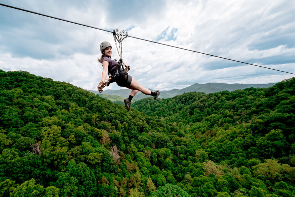 Woman ziplining of the treetops