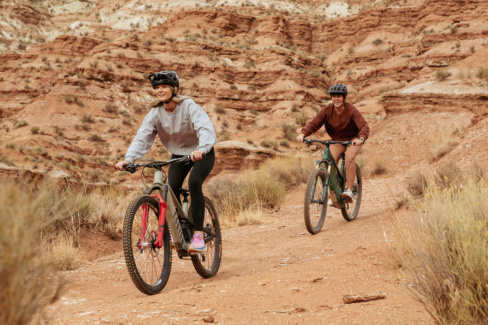 two women biking in the desert