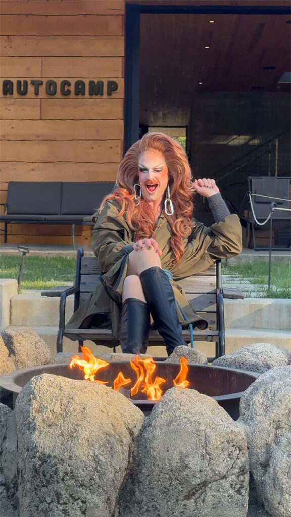 Patti Gonia in front of an AutoCamp campfire