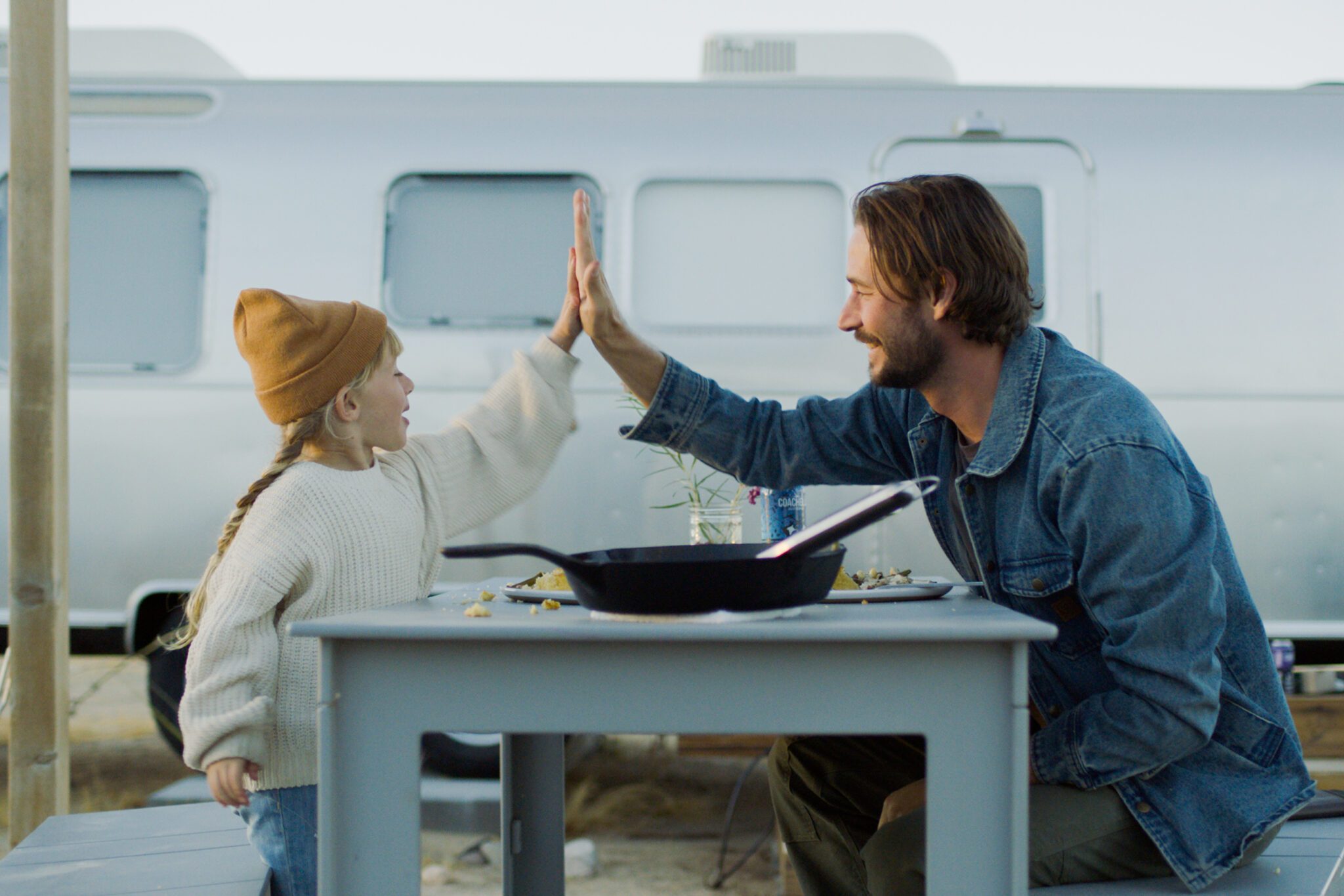 autocamp joshua tree father and daughter having dinner outside airstream